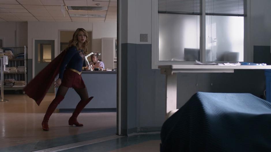 Kara slides to a stop outside James's hospital room.