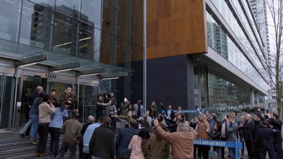 The guards escort Lex past a crowd after his sentencing.