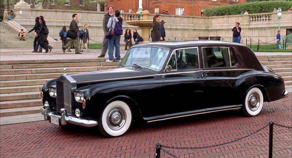 Harry's town car pulls up in front of the museum.