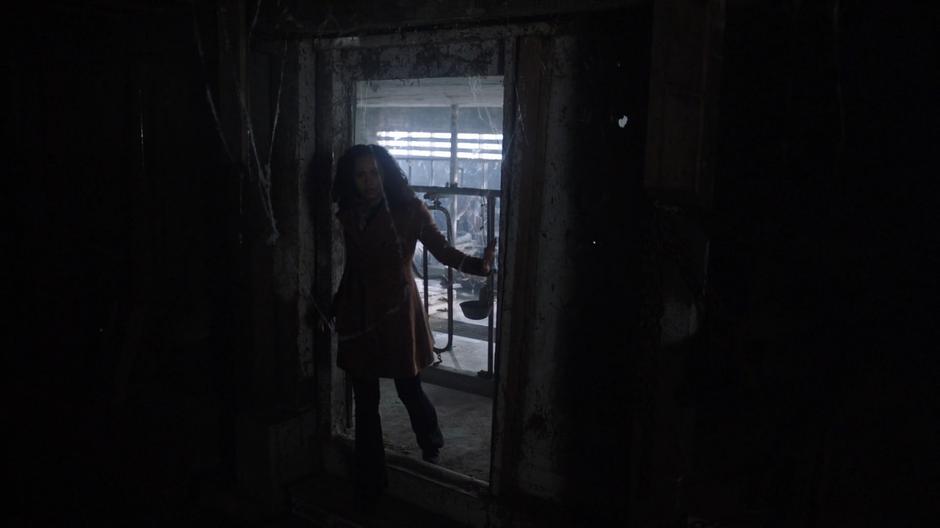 Macy searches around in a dark side room of the bed chamber.