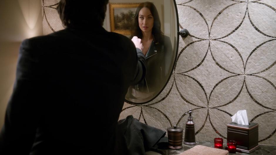 Ray reaches out to touch the bathroom mirror that Nora has appeared inside.