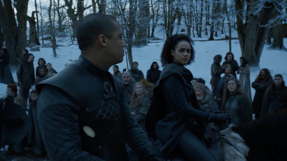 Missandei looks over at Grey Worm as they ride through the villagers and are met with distrustful looks.