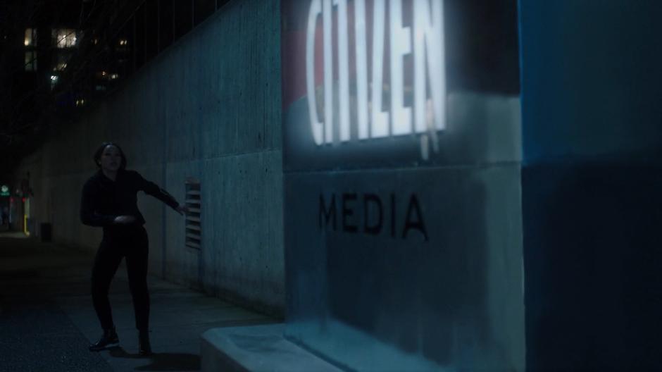 Nora runs to a stop next to the Central City Citizen Media sign.