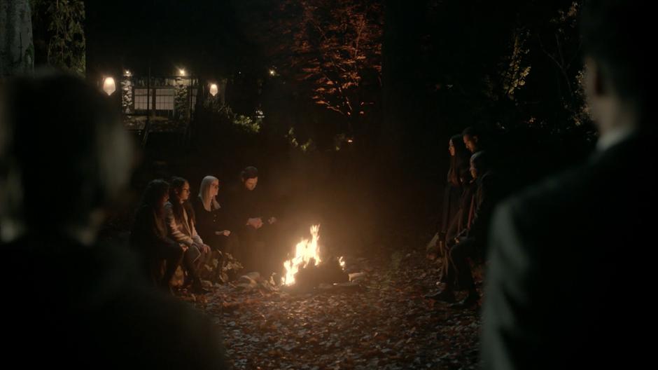 Quentin and the old Penny watch as their friends sit around the campfire remembering Quentin.