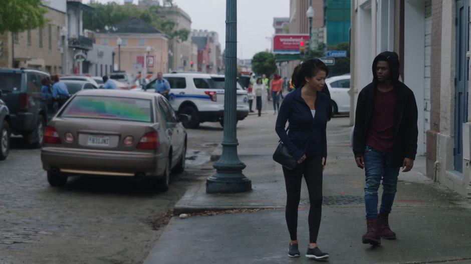 Adina and Tyrone try to look nondescript while walking away from the checkpoint.