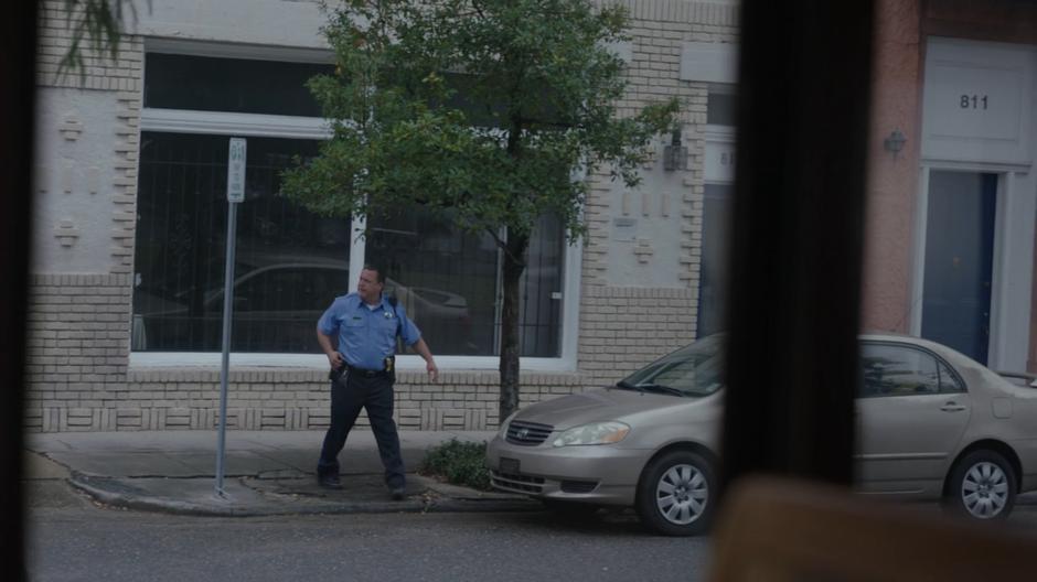 A police officer looks around for Tyrone and Adina but cannot find them.