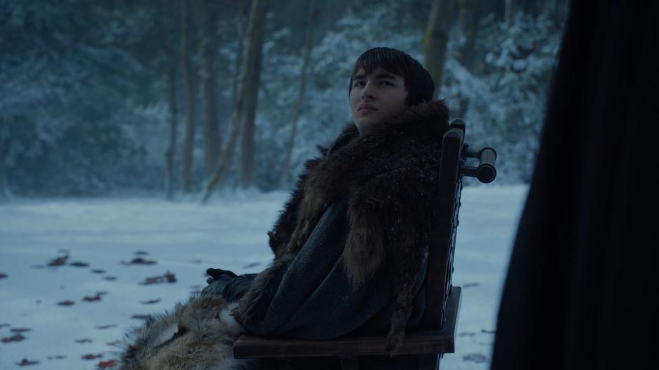 Bran looks up at Jaime as he approaches.