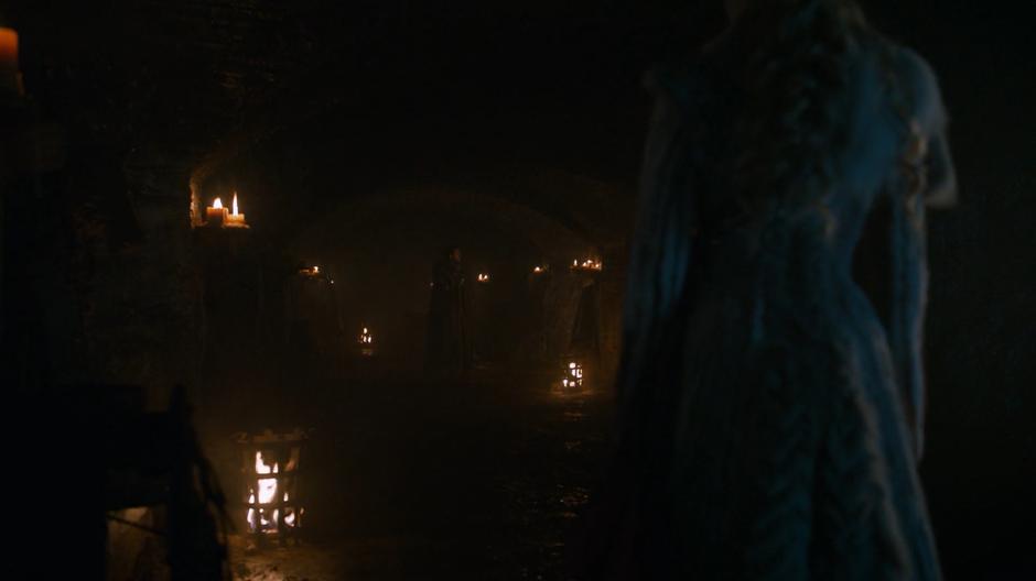 Dany stands at the end of the crypt as Jon stares up at a statue of Lyanna Stark.