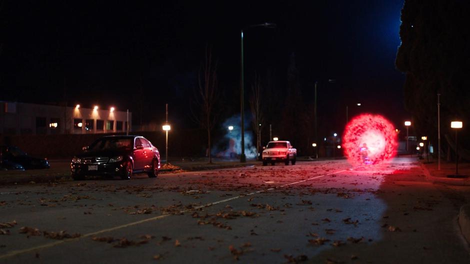 Nora emerges from a red portal from the future and races down the street.