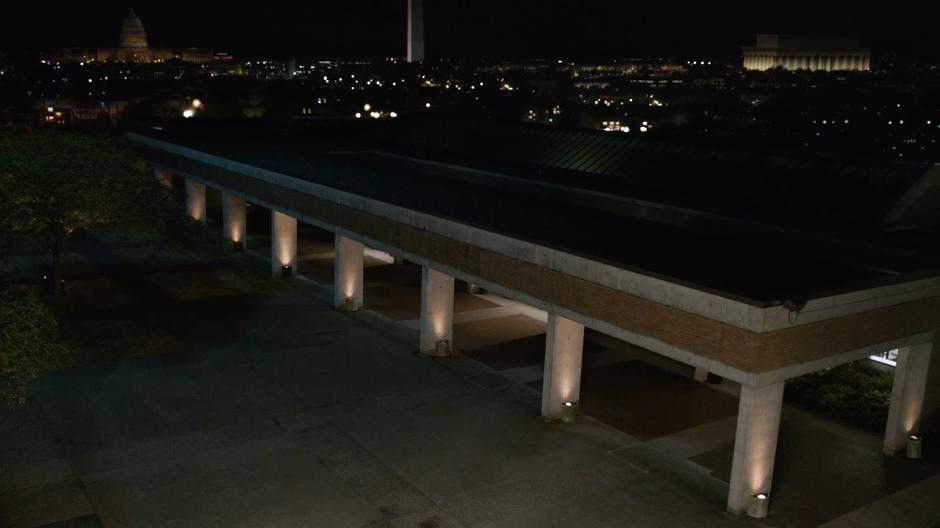 Establishing shot of the Time Bureau headquarters with various capitol buildings on the background.