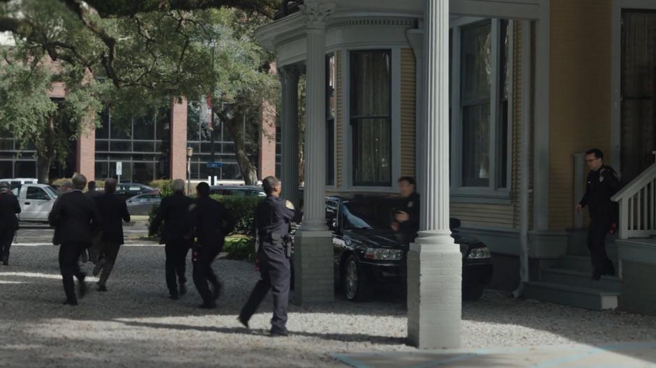 Security guards rush the last of the people out of the building.