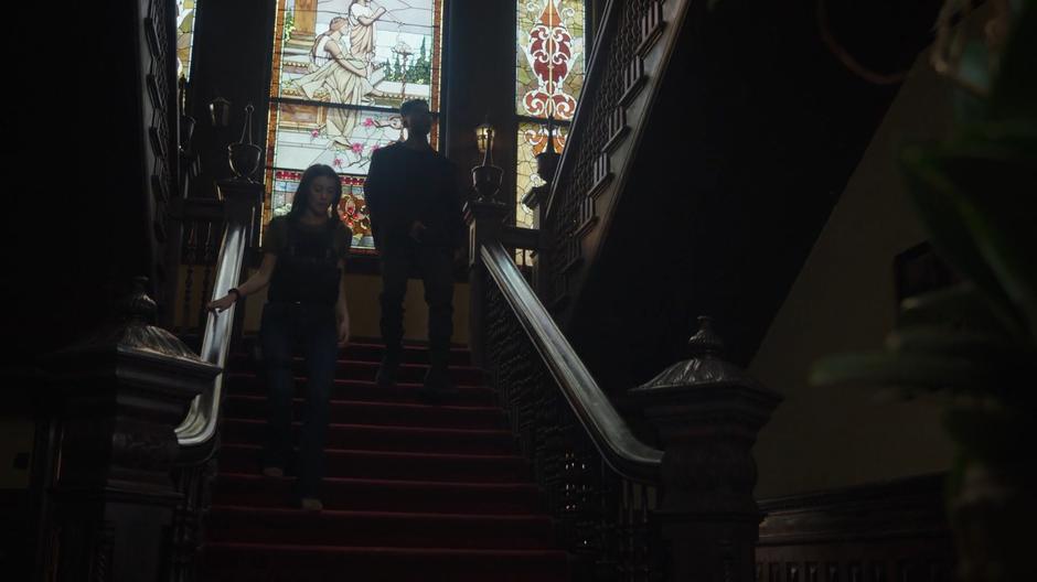 O'Reilly and Tyrone walk down the stairs towards the wine cellar.