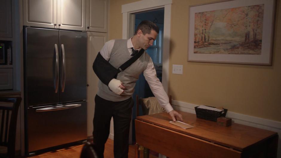 Ben Lockwood picks up the mail from the table after entering his home in the evening.