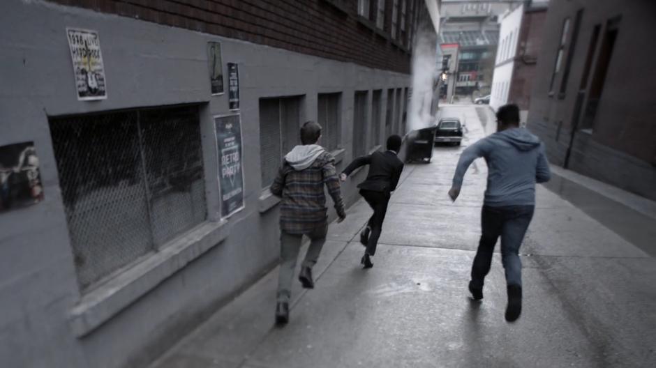 Young James runs away from the two bullies down the alley.