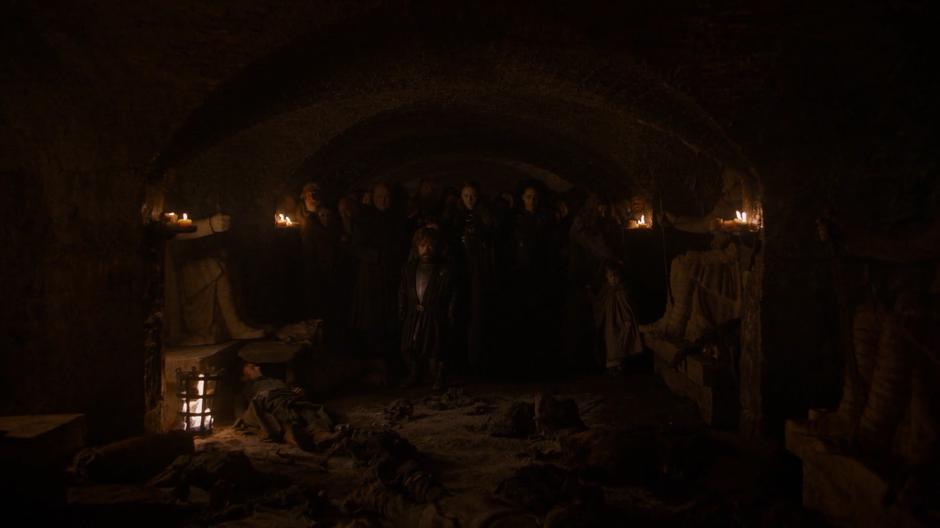 Varys, Tyrion, Sansa, and Missandei walk through the crypt with the other survivors after the wights return to death.