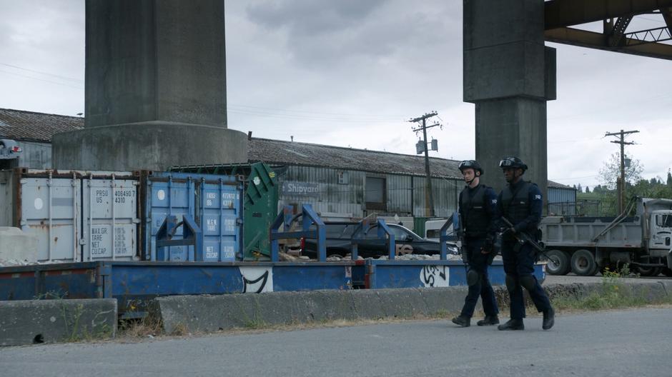 Major and Justin walk down the street near the checkpoint.