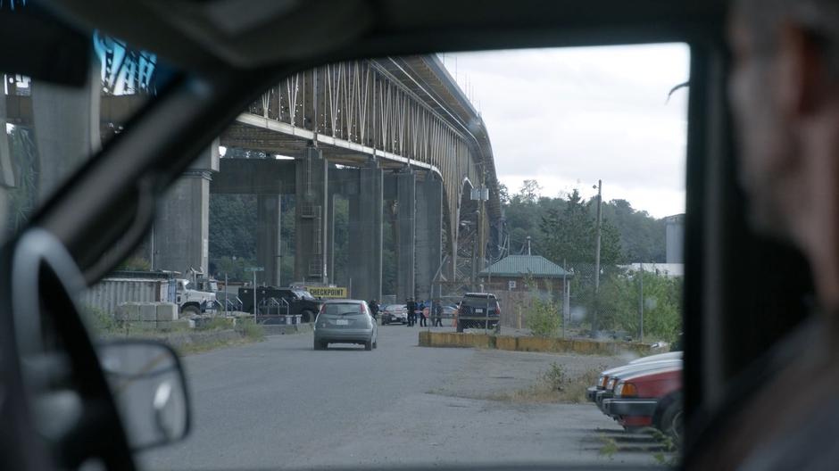 The bomber watches the checkpoint from his van waiting for the predetermined time.