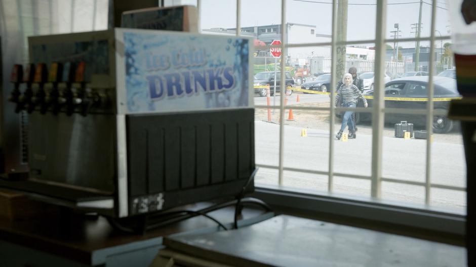 Liv and Ravi walk across the street from the crime scene to the store.