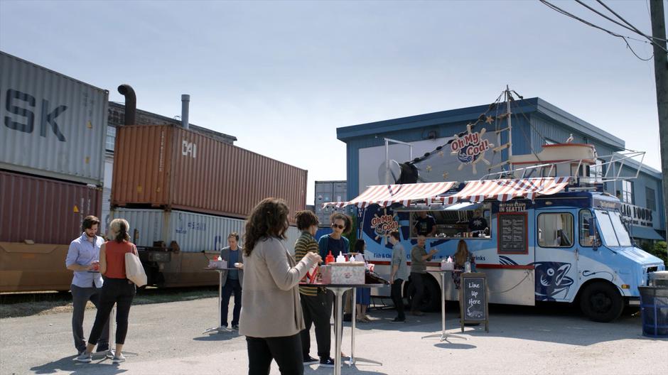 People mill around in front of Dolly Durkins's fish & chips truck.