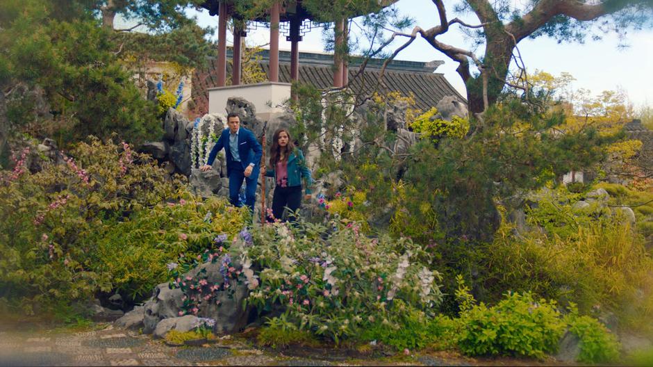 Harry and Maggie climb across some rocks towards Charity.