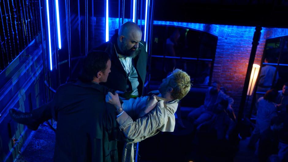 Constantine tries to convince Calibraxis not to have him killed while the goon holds him over the railing.