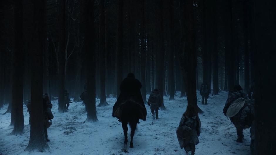 Jon rides in the middle of a group of Wildlings as they head into the forest north of The Wall.
