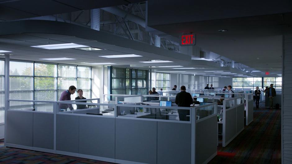 Liv and Ravi chat amongst the cubicles while waiting for Clive.