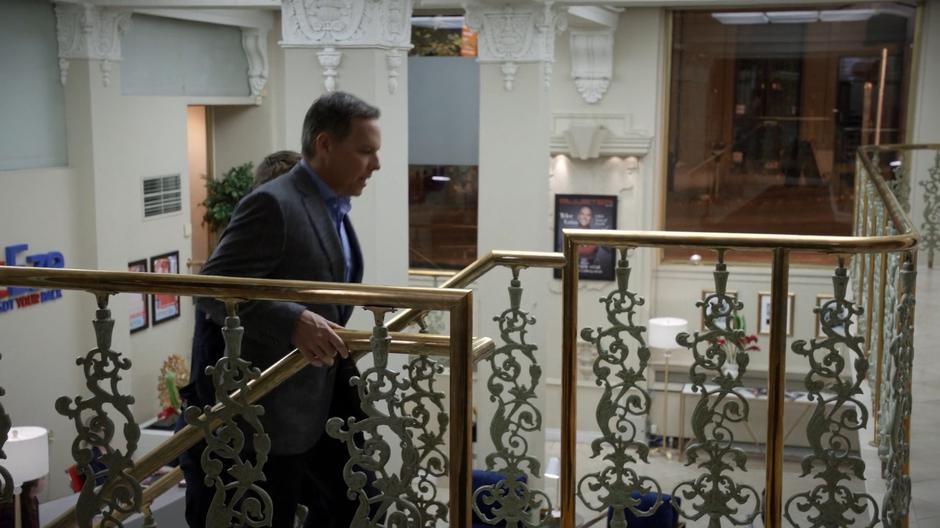 Major and Ty Griss walk up the stairs to his office.