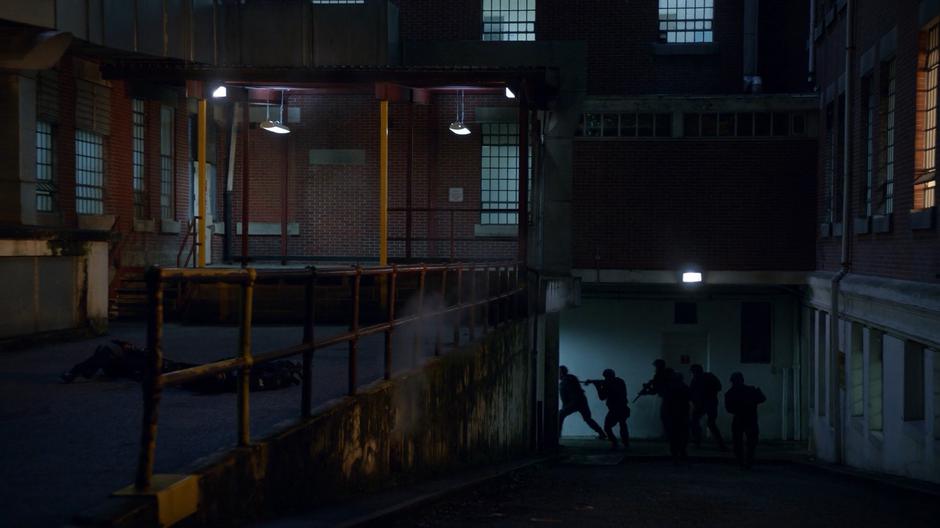 A group of soldiers enter the building's basement after killing two guards.