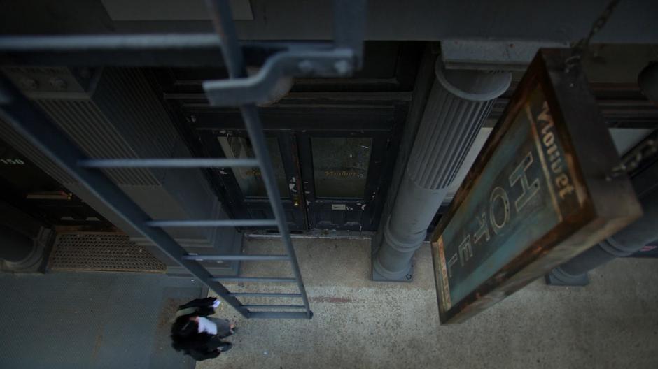 Jessica approaches the door of the hotel.