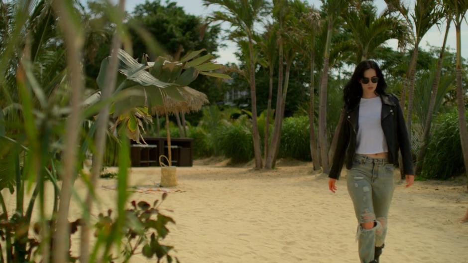 Jessica walks across the beach looking for her quarry.