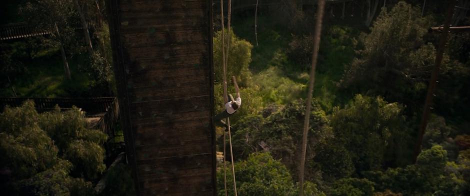 Carol misses the rope she was leaping towards and falls to the ground.