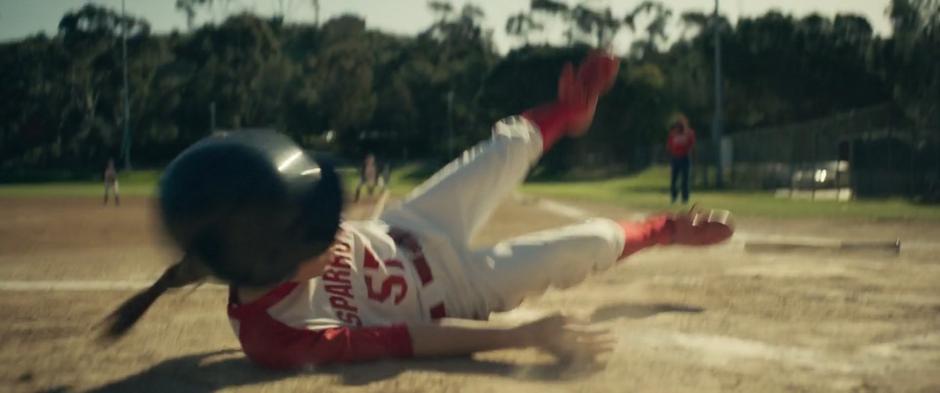 Young Carol falls to the dirt after dodging out of the way of a foul ball.