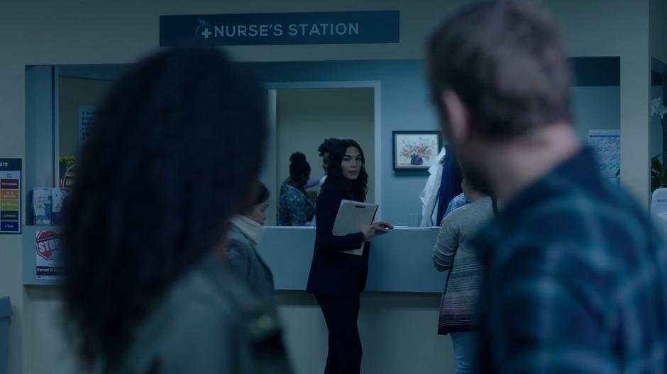 Maddie and Ben turn to where Helen is standing by the nurse's station.