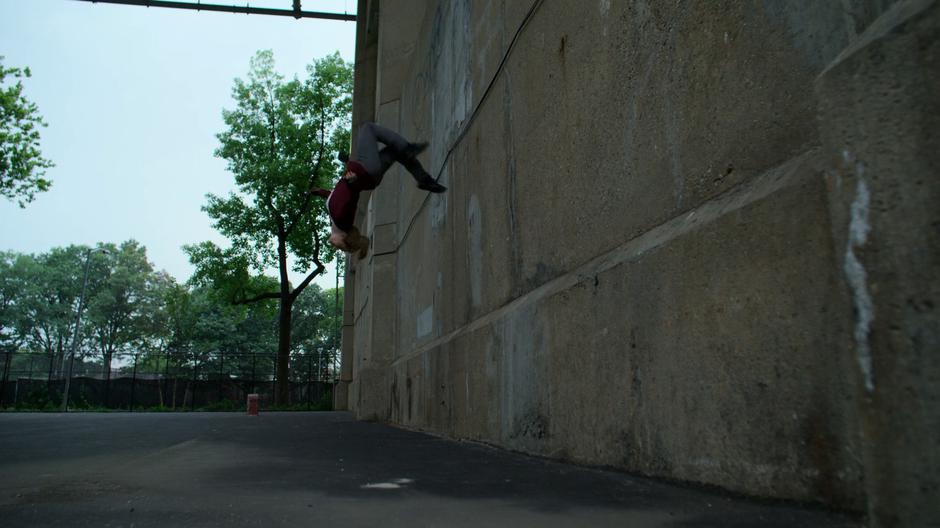 Trish does a backflip off the bridge support column.