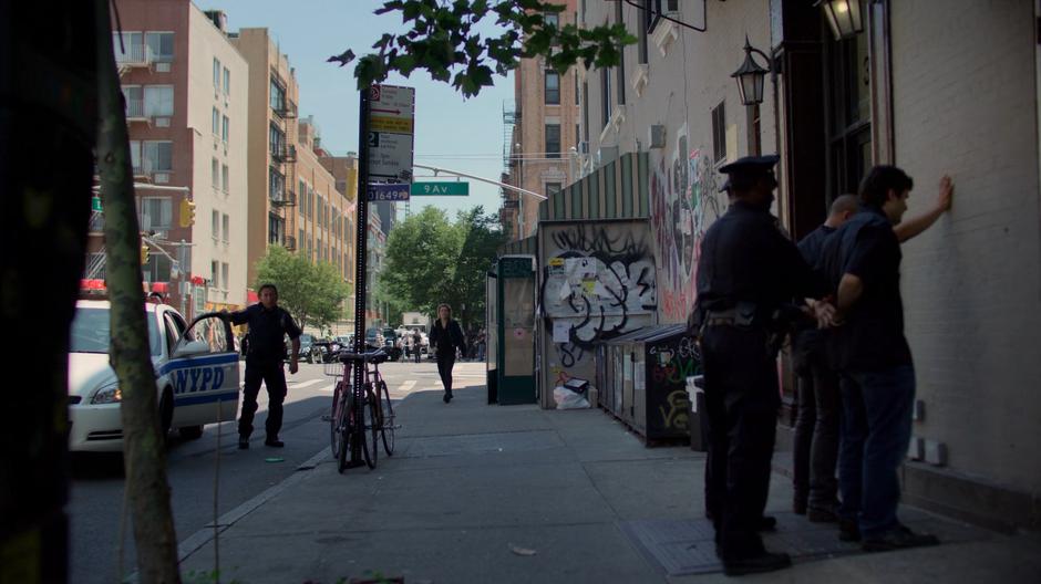 Trish comes to a stop when she see the police have already apprehended the suspects.