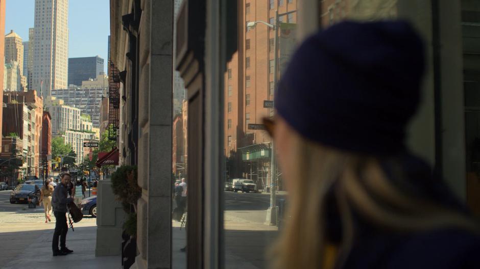 Trish watches Andrew Brandt as he zips up his backpack after making a deposit.