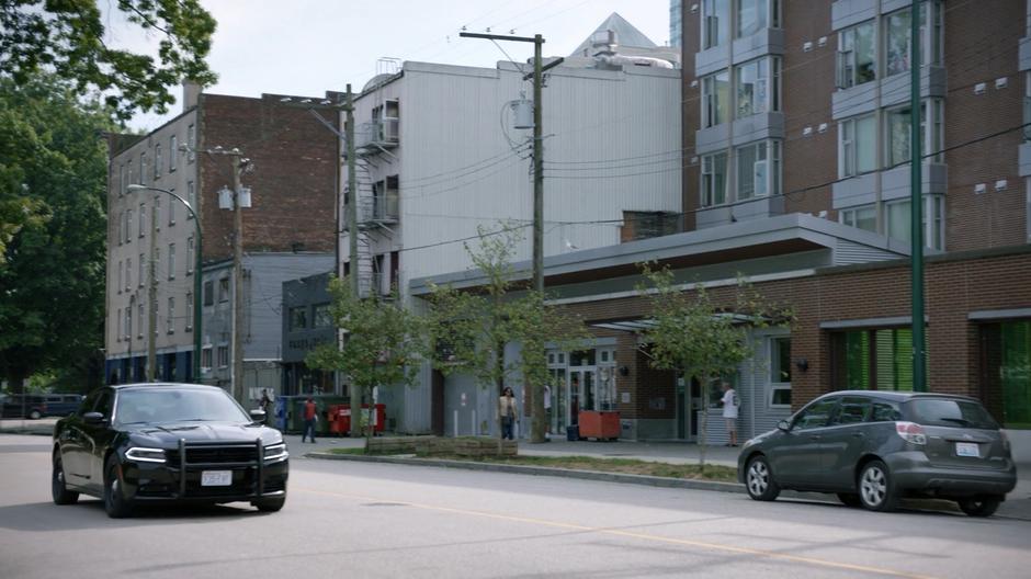 Clive drives his car down the street with Liv.