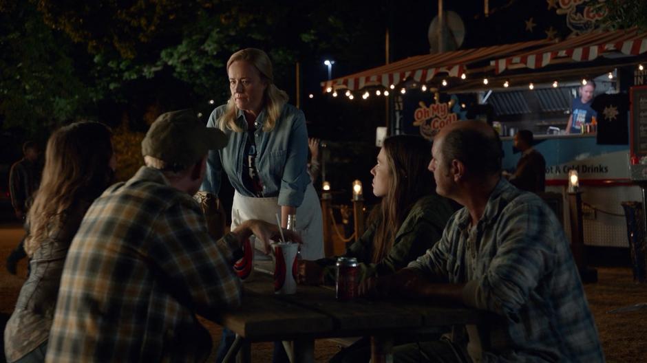 Dolly Durkins talks to a table of humans and plays up the attack on the bar.