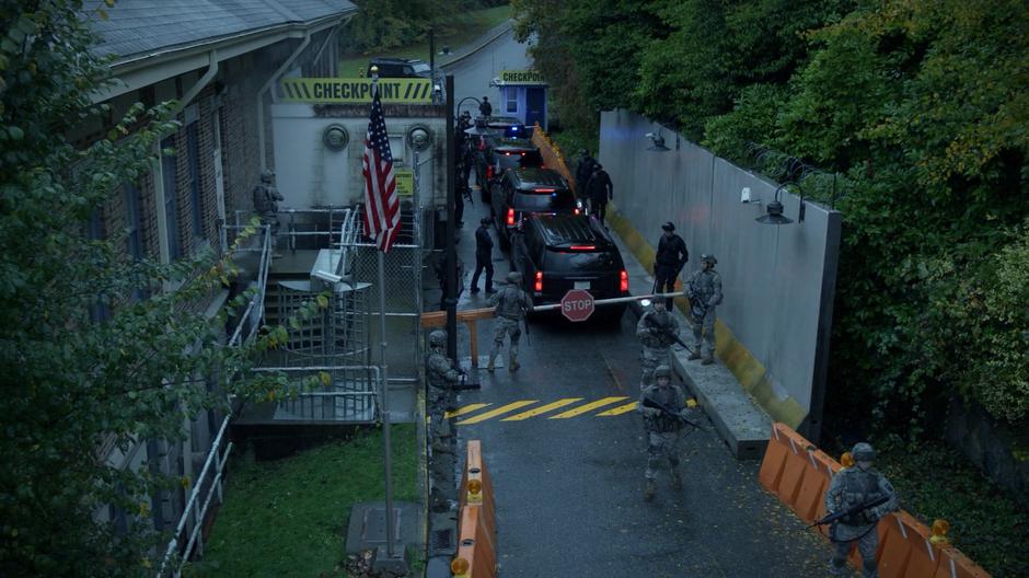 Four government vehicles stop at the checkpoint on their way into Seattle.