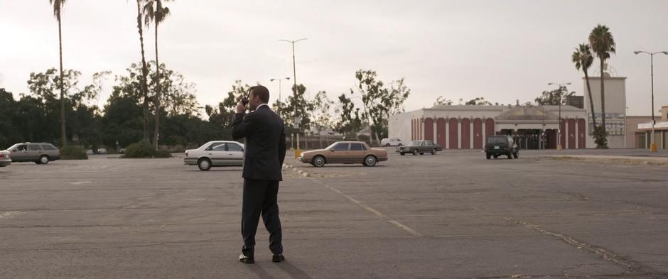 Coulson stands in the empty parking lot calling Fury on the radio.