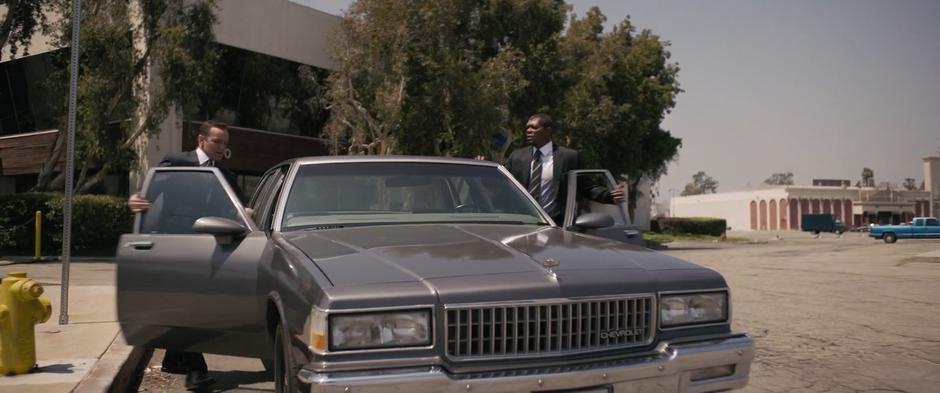 Coulson and Fury get into their car to chase after the two suspects.