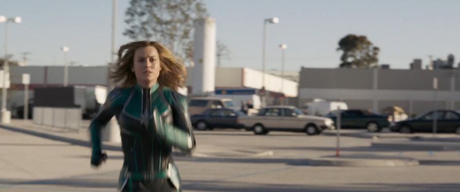 Vers races across the parking lot towards the station after the fleeing Skrull.