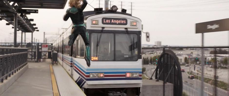 Vers leaps from the platform onto the back of the departing train.