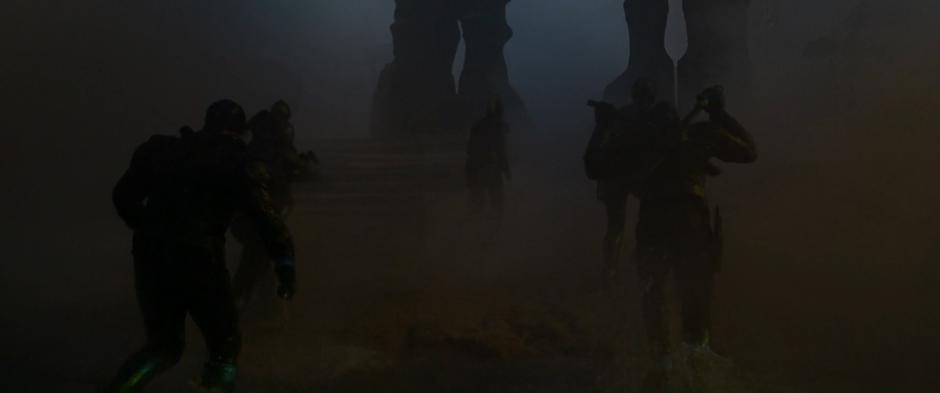 Vers and the rest of the team emerge from the water and head across the foggy landscape.