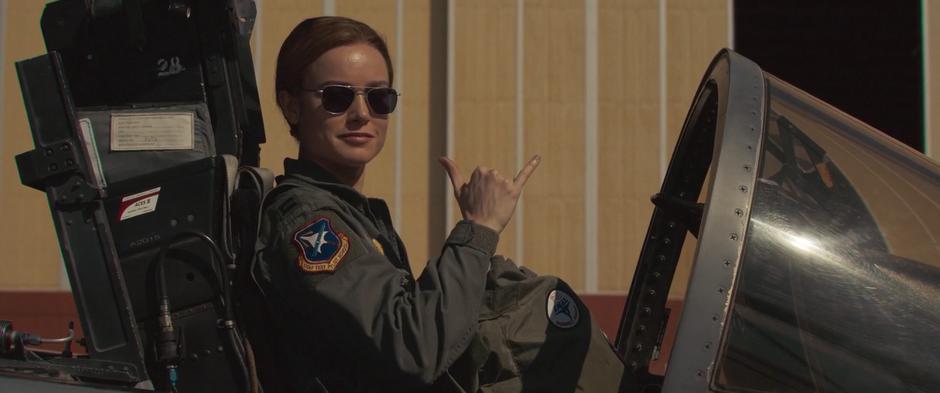 Carol gestures at Maria from her cockpit.