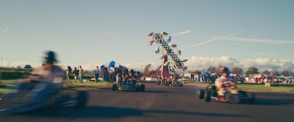 Kids race around the track in their Go-Karts.