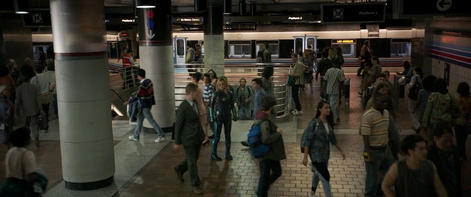 Vers stands in the middle of the busy station looking around for any sign of the Skrull.