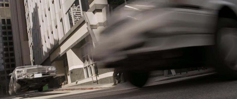 Fury's car gets a few feet of air while racing out of the alley in pursuit.