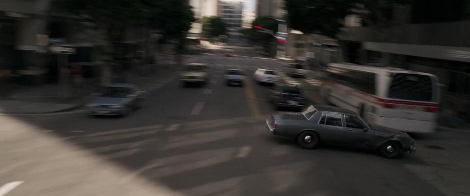 Fury drives his car across the busy street into the next alley.